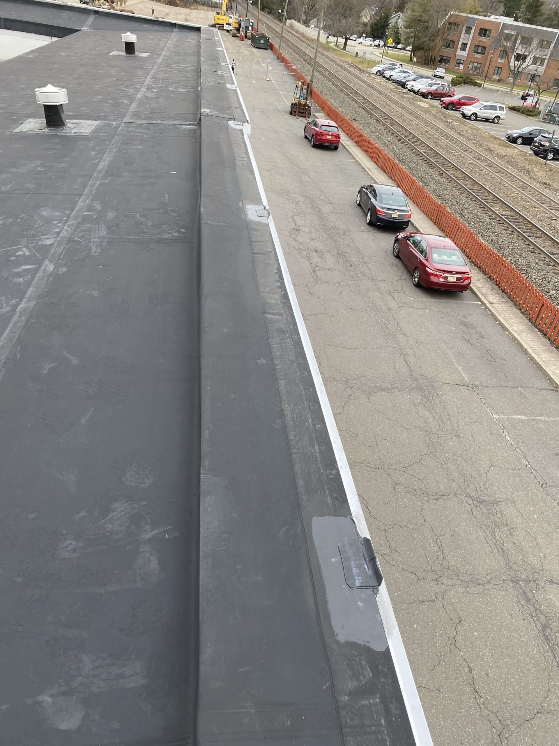Commercial flat roof membrane with repair patches